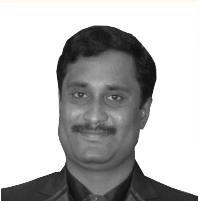 Senthil Anand, in a dark jacket over a dark shirt, photographed head-on in black and white.