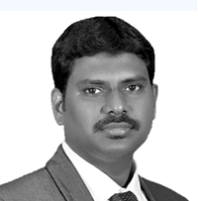 Sundar Raman, in a grey suit and dark tie, photographed head-on in black and white.